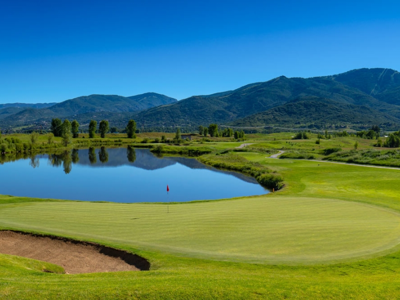 Golf hole with mountains in background